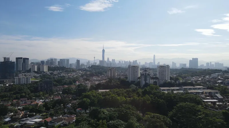Kuala Lumpur skyline seen over Taman Desa's tree canopy, developer's site photo