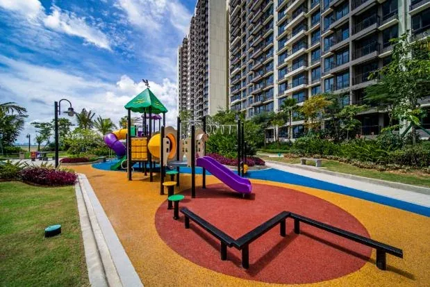 Children's playground with slides beside an apartment block at Country Garden Central Park