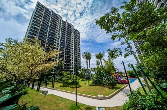 Apartment block rising above a landscaped garden path at Country Garden Central Park