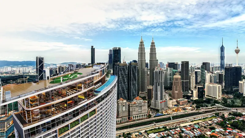 Aerial view over the KL360 sky deck and cliff pool with the Petronas Twin Towers, Merdeka 118 and KL Tower on the skyline, artist's impression