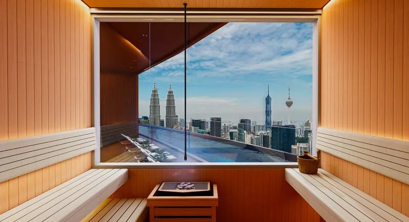 KL360 sauna room with a panoramic window facing the Petronas Twin Towers and KL Tower, artist's impression