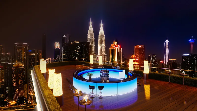 KL360 sky bar at night with the Petronas Twin Towers in the background, artist's impression