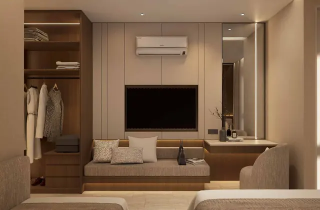 MABA Suitez Type A studio living area with TV wall and bench seating in Walnut Elegance, artist's impression