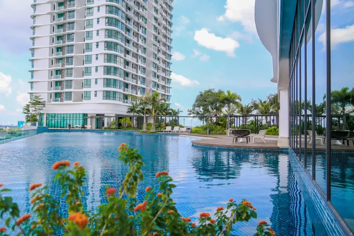 Swimming pool with a Macrolink Medini tower rising behind it, Medini, Iskandar Puteri