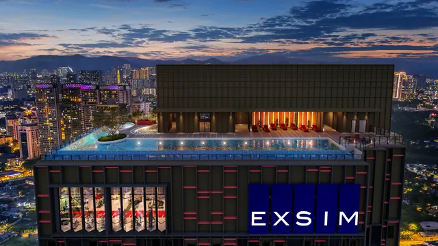Sky facilities at the top of Phoeniz Suites @ KL City Centre: pool deck above a glass-fronted gym at dusk, artist's impression