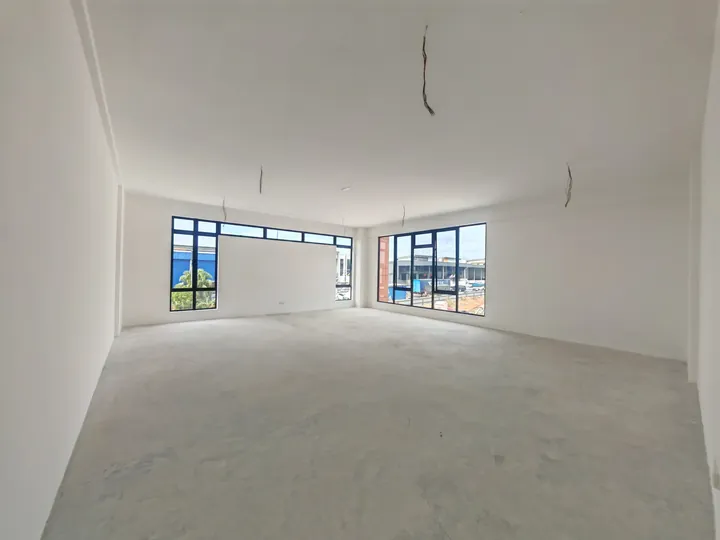 First-floor office space with corner windows inside a Setia Edge factory, photographed on site