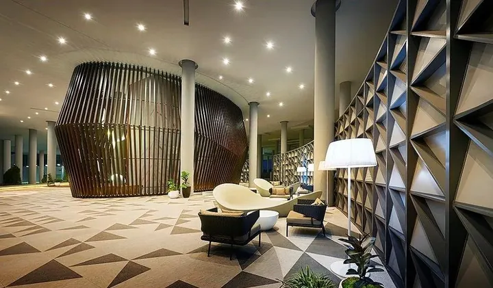 Lobby lounge with a timber pavilion and geometric screens at Southern Marina Residence