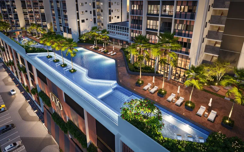 Level 6 infinity pool and pool deck at The Straits View Duo from above at dusk, artist's impression