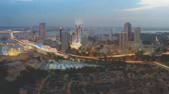 Johor Bahru city skyline at dusk with the Suasana Iskandar tower lit beside the CIQ complex and the road to the causeway