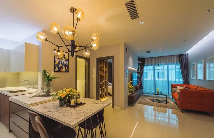 Living and dining area with island kitchen in a Suasana Iskandar show unit